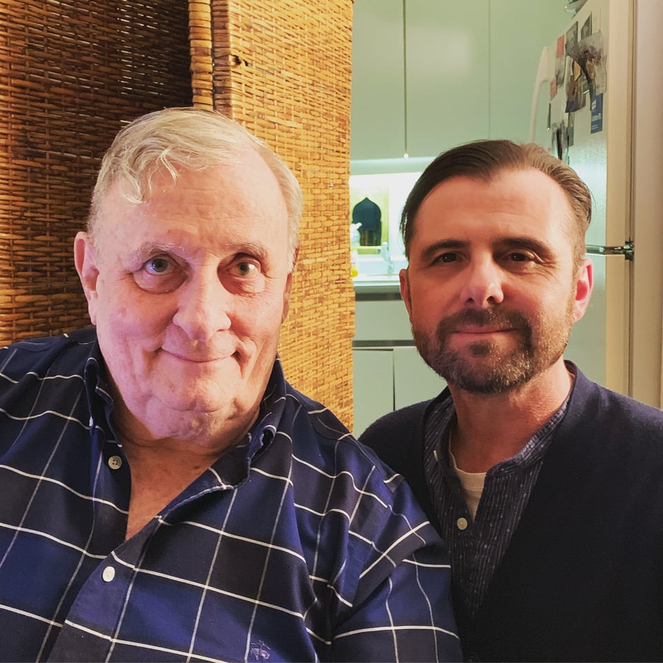 Photo of two white men: left, author Edmund White; right, his husband Michael Carroll