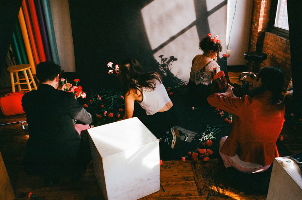 the 4 folks of sorry darling cleaning up flowers after a photoshoot