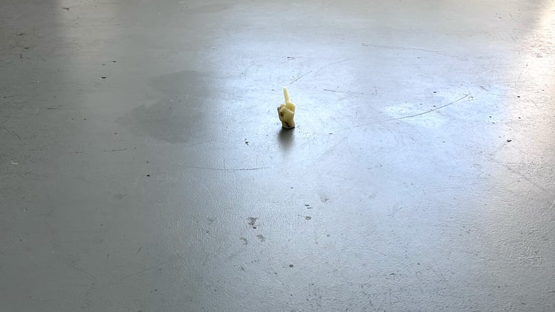 A wax hand, flipping the bird, made of wax, with studio keys embedded inside. Because I am petty.