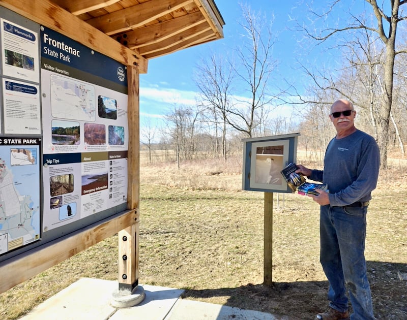 Longtime FSP/A stalwart Wally Siewert inaugurates the new Little Library he built for the FSP campground. / Photo by Steve Dietz