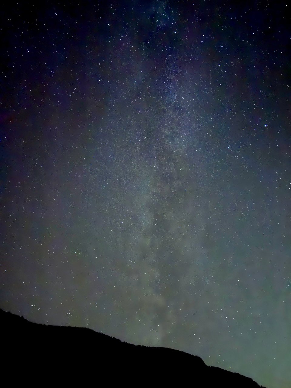 The Milky Way rising over a hill.