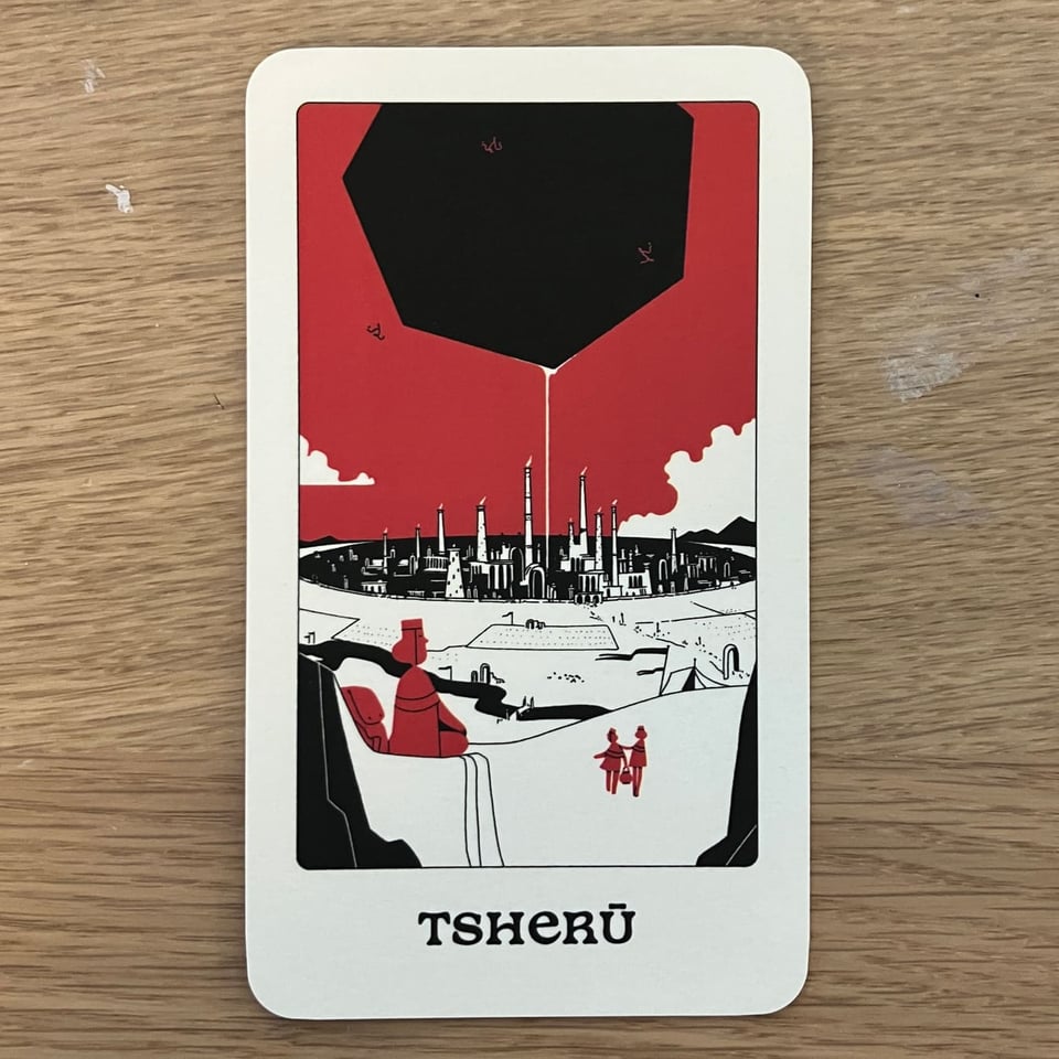 A preview of the Tsherū card, showing a view of the city from a distance. A massive, black heptagon hovers overhead.