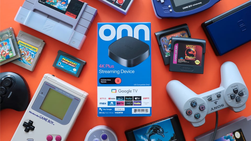 a collection of retro gaming consoles and games surrounding the Walmart ONN 4K Plus TV box