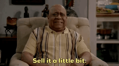 Older man in a chair saying sell it a. little bit