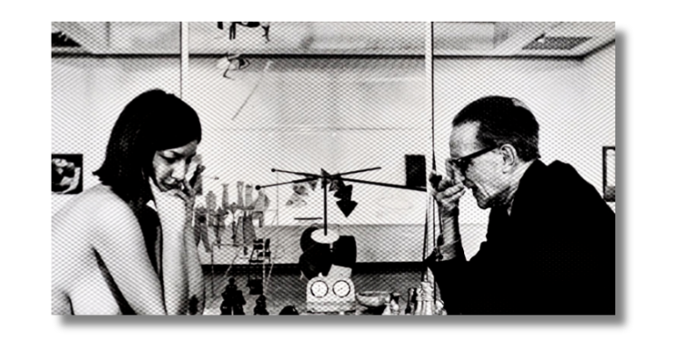 Writer Eve Babitz playing chess, naked, with the artist Marcel Duchamp, clothed