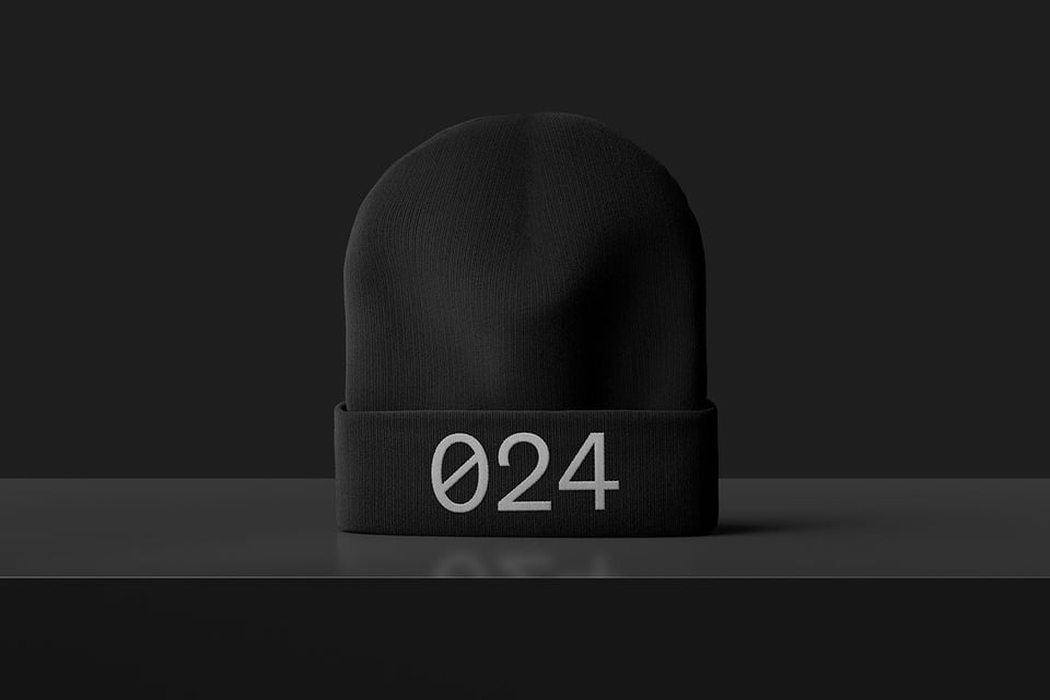 Front view of a black beanie with embroidered design stating 024