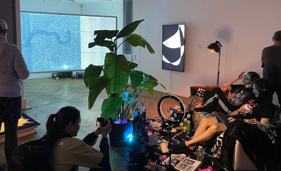 Artist performance happening in Prachtsaal Studio with some video artworks hanging on the background