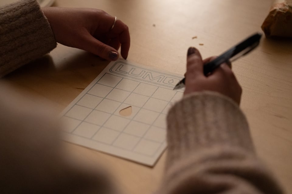 Lizzie starting to fill out a bingo card.