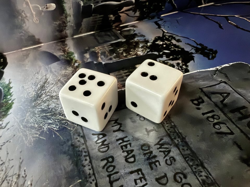 A pair of dice with pips in strange places