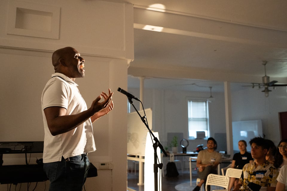 Rashaun telling a story to a small crowd.