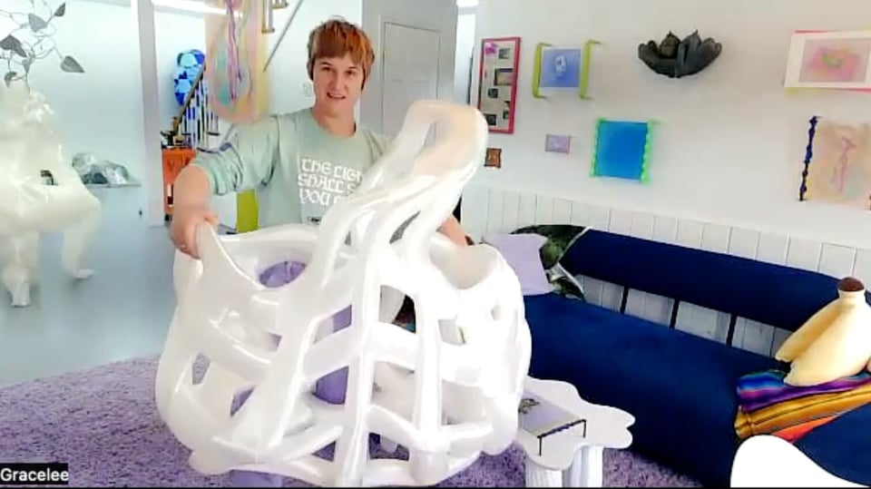 Gracelee holding a giant printed basket in her living room.