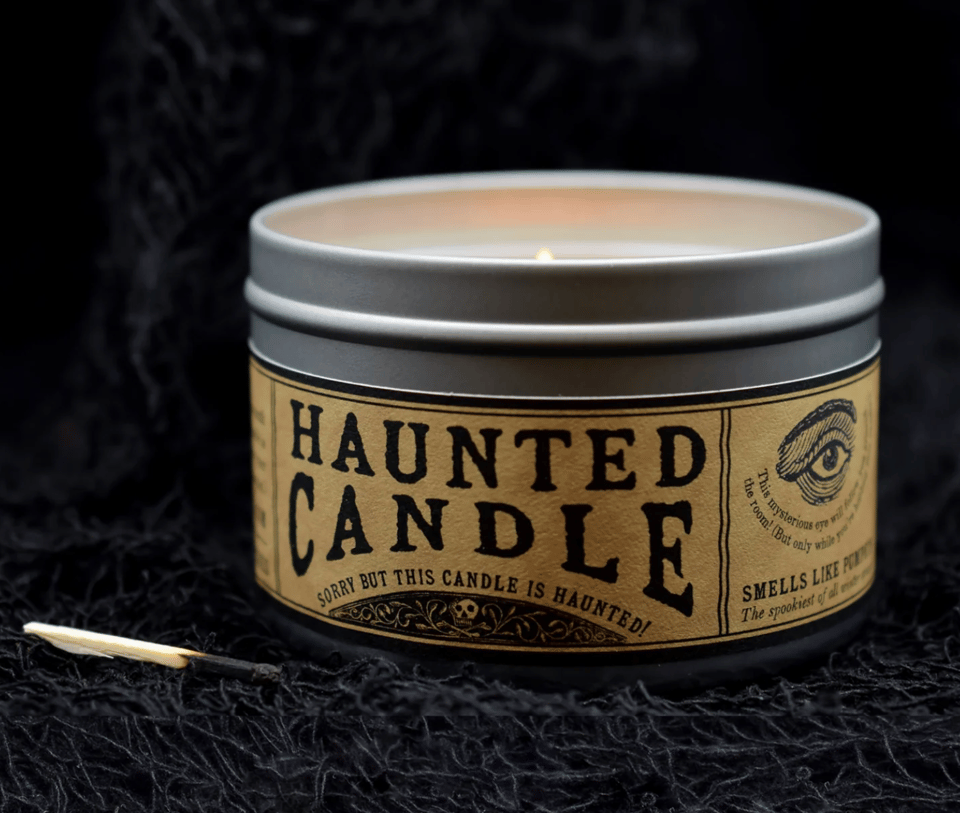 A candle labeled "Haunted Candle: Sorry but this candle is haunted!"