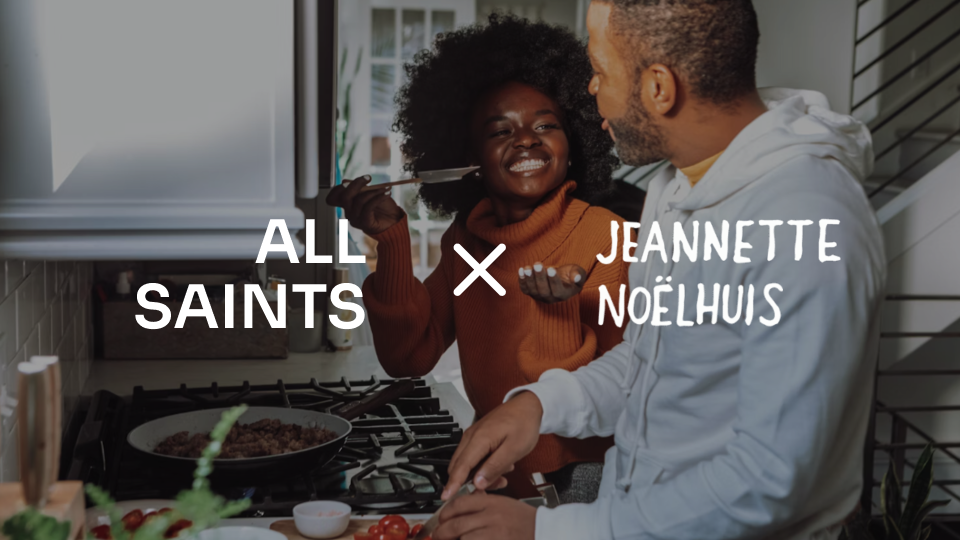 A Black woman and man joke around in the kitchen