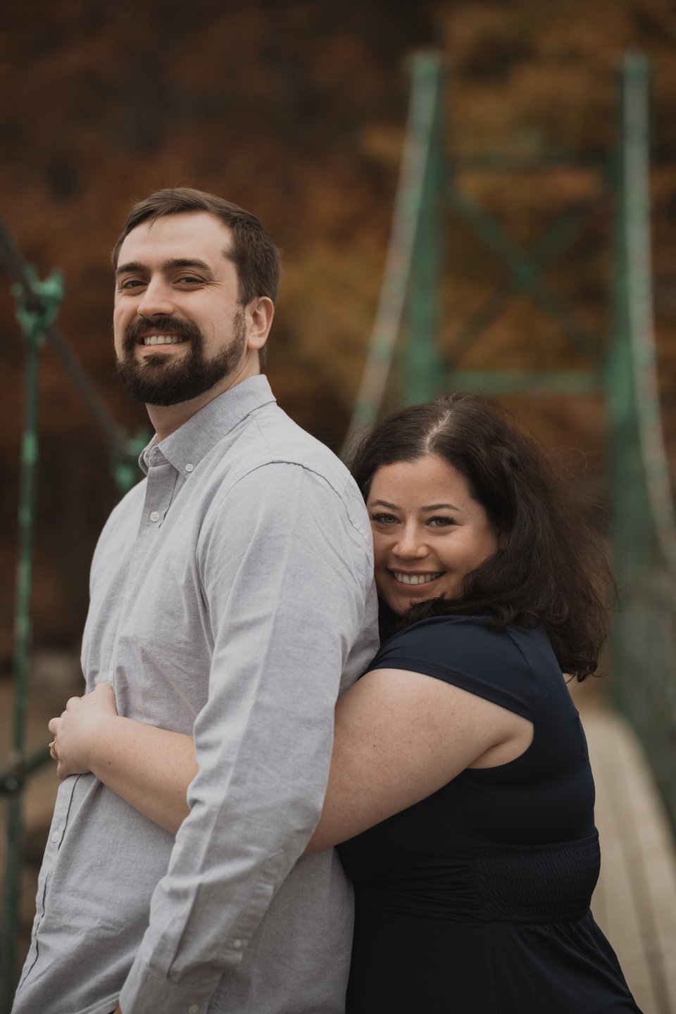 a couple embracing on a bridge