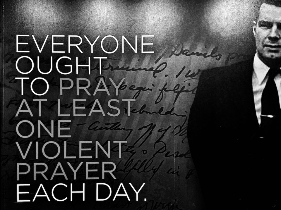 Black, white, and gray photo of the quote "Everyone out to pray at least one violent prayer each day." A handwritten letter is enlarged and out of focus in the background, while the late Gordon Lindsay is standing to the extreme right of the frame.