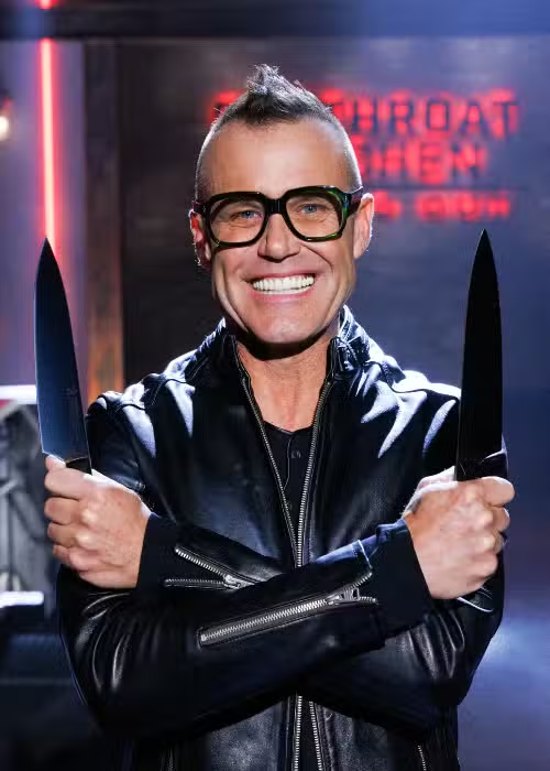 a man holding two knives