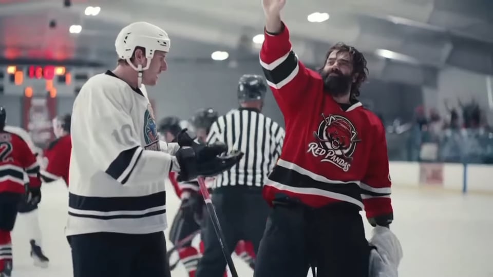 A man wearing a hockey sweater that says "Red Pandas."