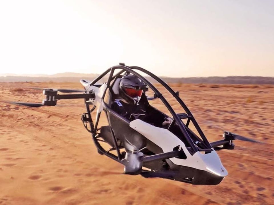 Man flying an aerial drone over a desert