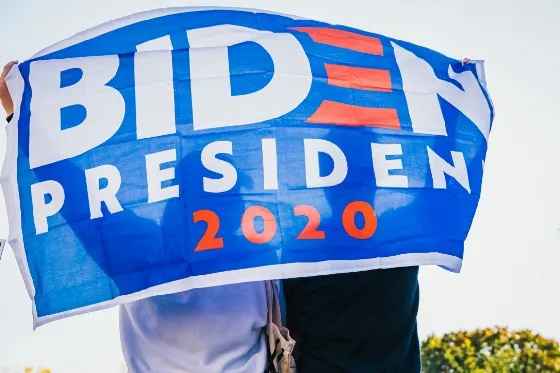 two people holding a biden president 2020 banner