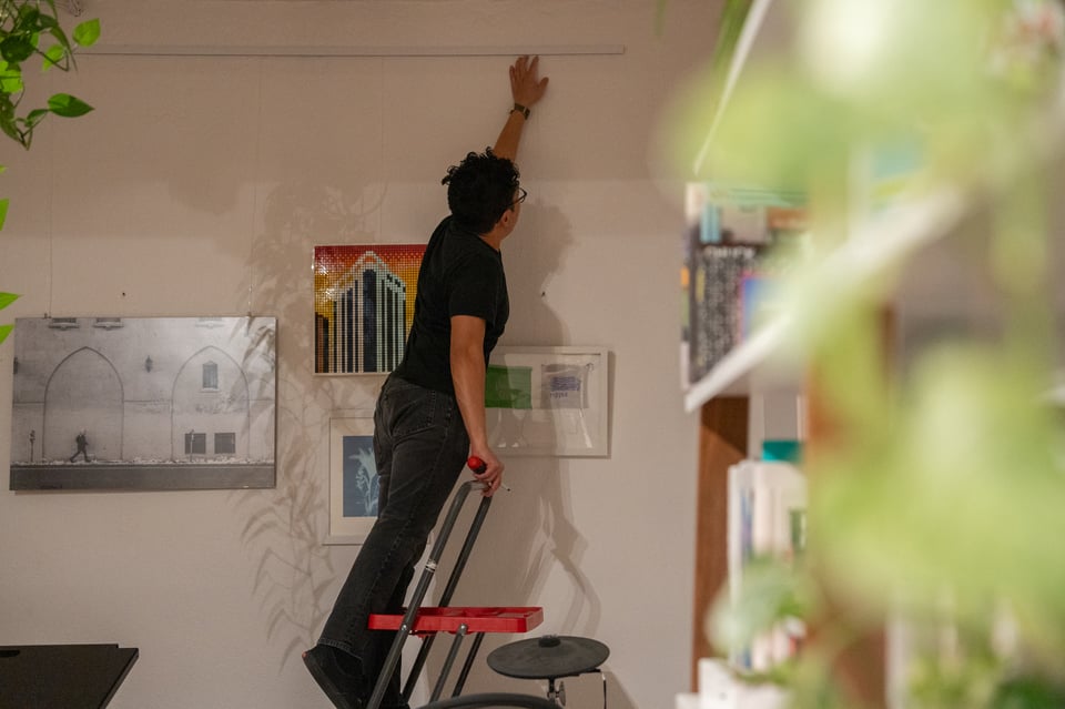 Norton hanging some art.