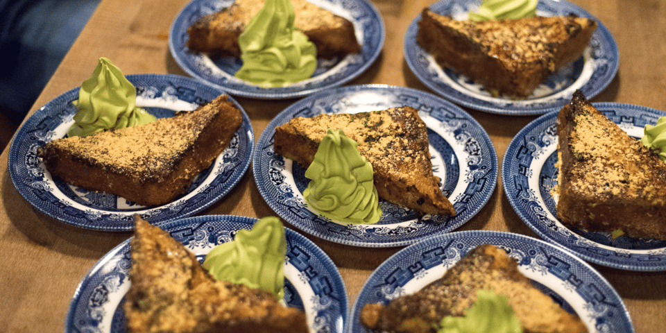 Plates of golden French toast with vivid green matcha ice-cream.