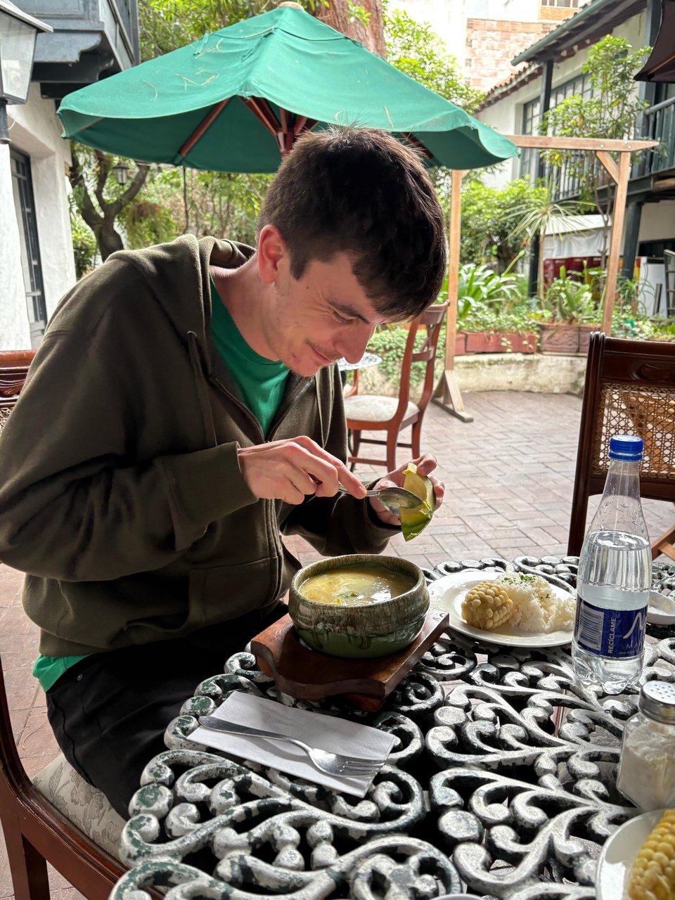 Me digging into an ajiaco soup in Bogotá