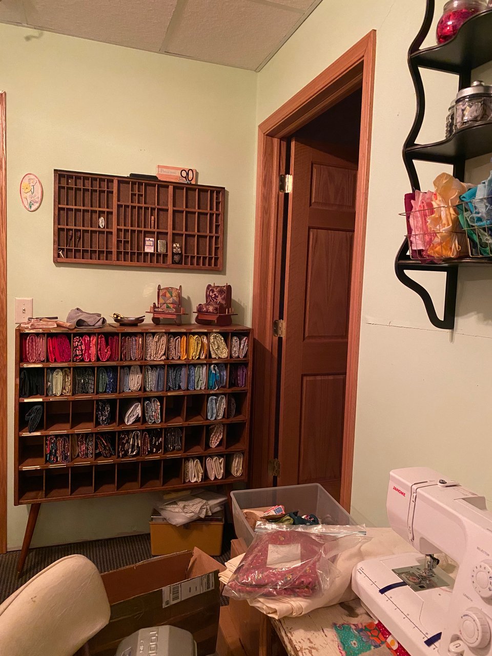 a vintage mail sorter filled with colorful fabrics