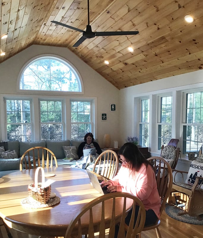 a woman sitting at a table in a living room