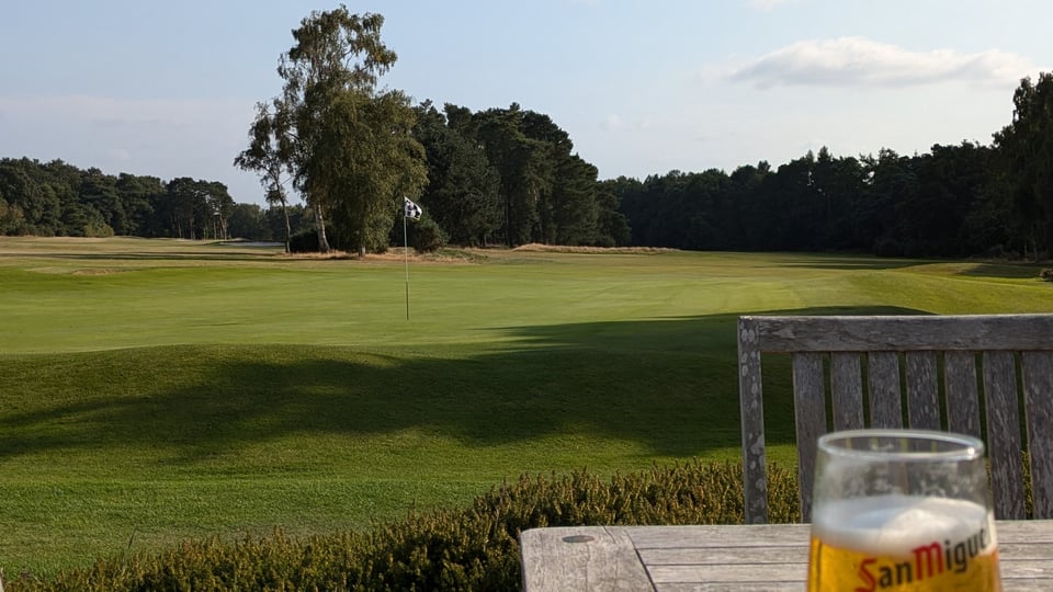 Northamptonshire County 18th green from the clubhouse patio in afternoon sun