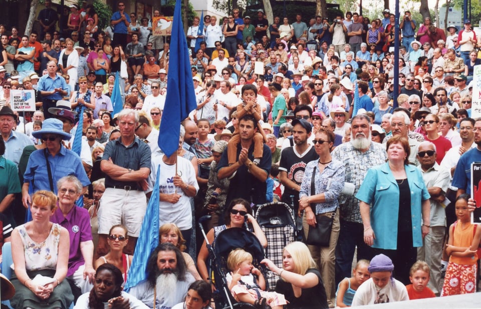 Large crowd of people gathered for an anti-war rally