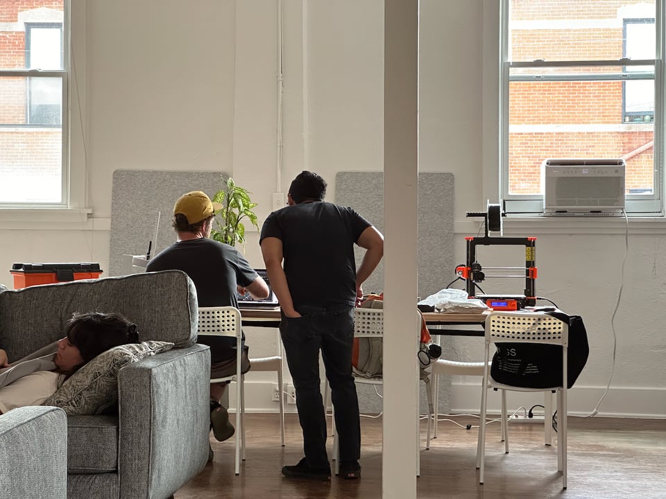 Norton looks at Jeremy’s work while Livvy takes a nap.