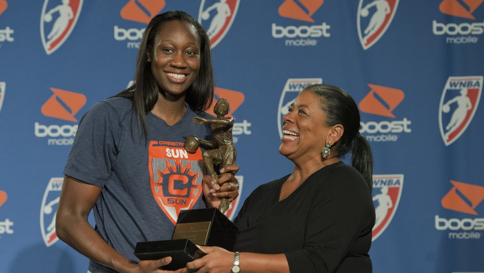 Tina Charles accepts her 2012 WNBA MVP trophy from WNBA Commissioner Laurel Richie