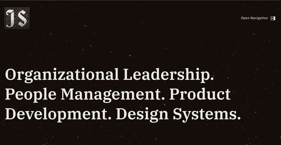 A screenshot of my website's dark-mode homepage. My brandmark sits in the top left corner; the "Open Navigation" button is in the top right; there's large text that reads "Organizational Leadership. People Management. Product Development. Design Systems."
