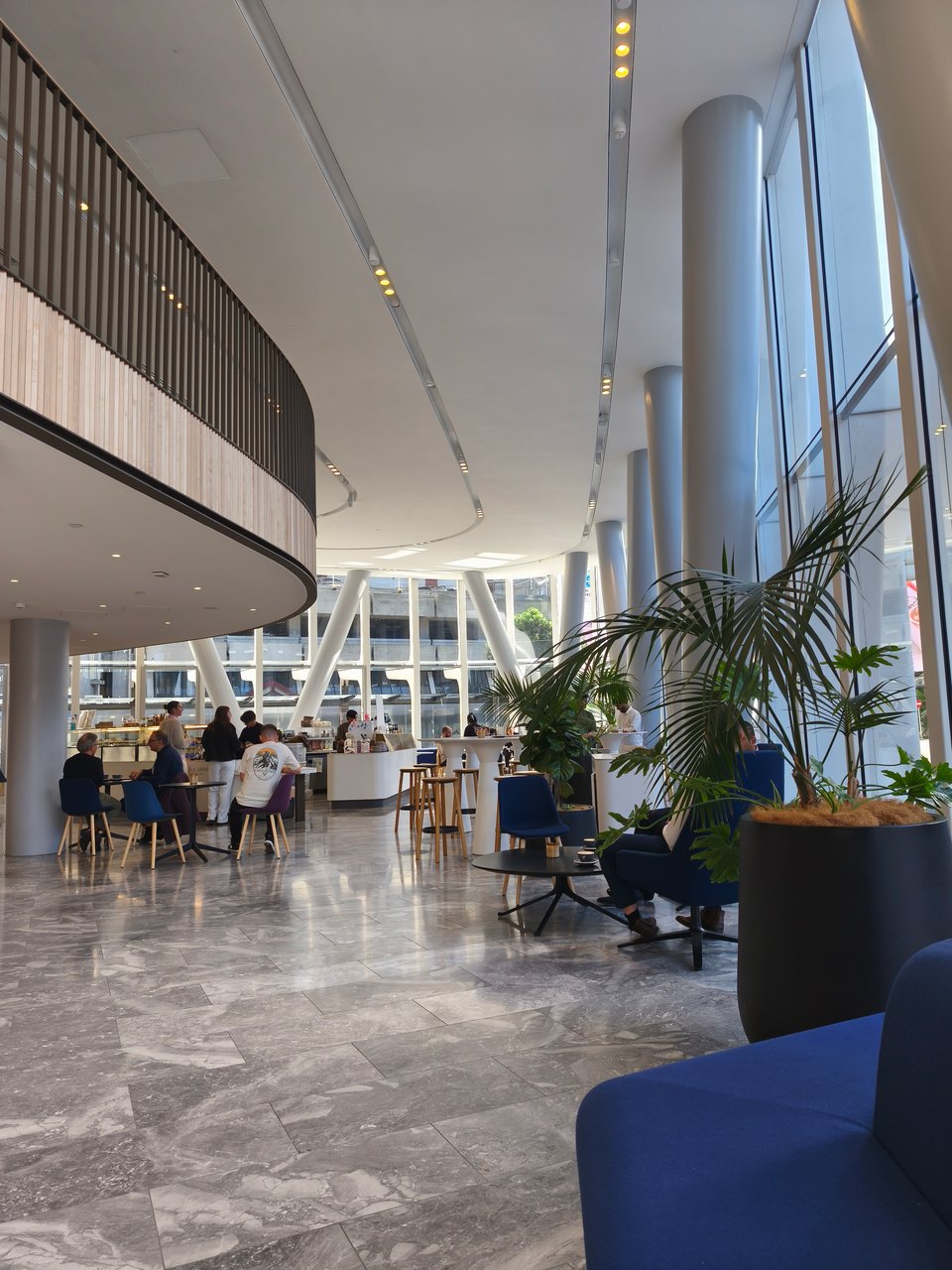 large cafe atrium, lots of glass and windows and people looking busy