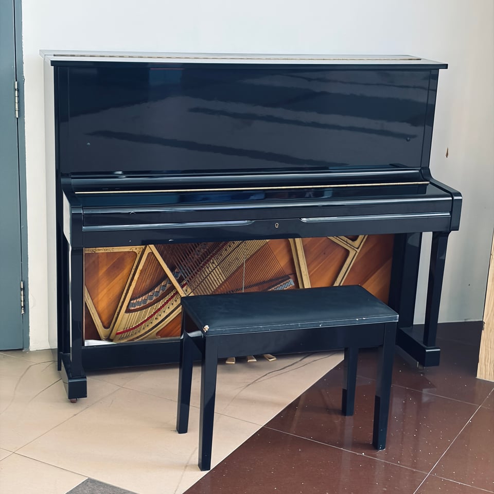 the upright piano that sits in the foyer