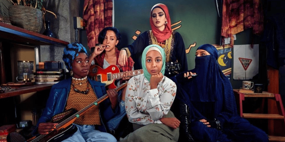 The cast of We Are Lady Parts - five Muslim women with guitars.