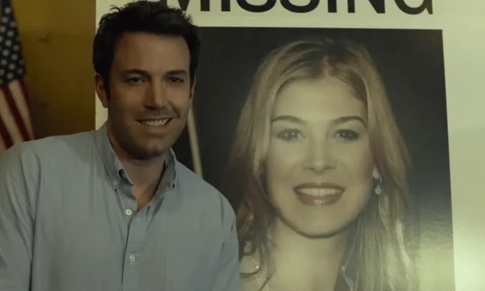 Ben Affleck in Gone Girl smiling next to a picture of the Gone Girl
