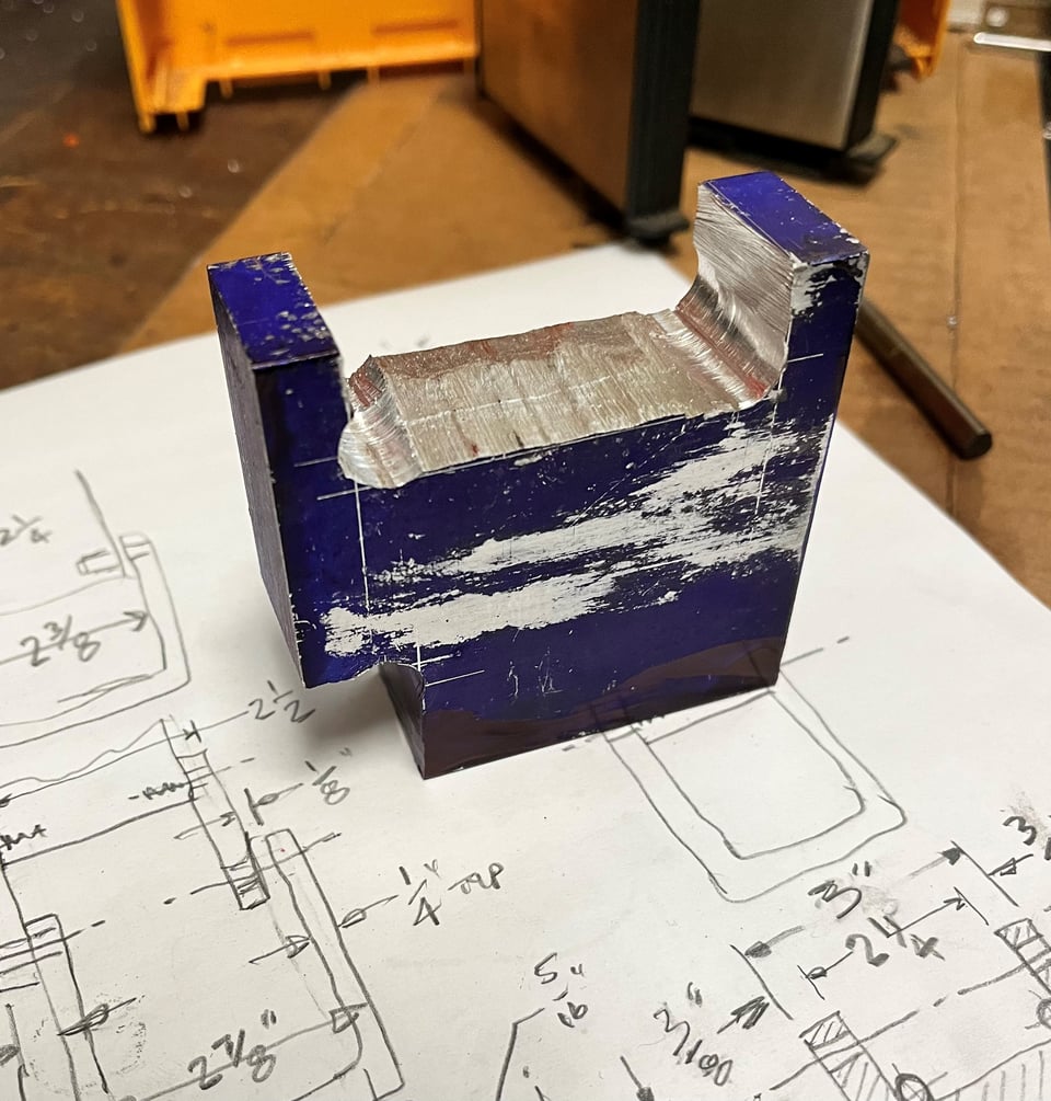 the block of aluminum carved into the approximate shape of the part