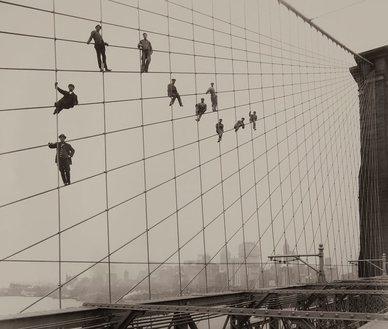 painters suspended on bridge cables