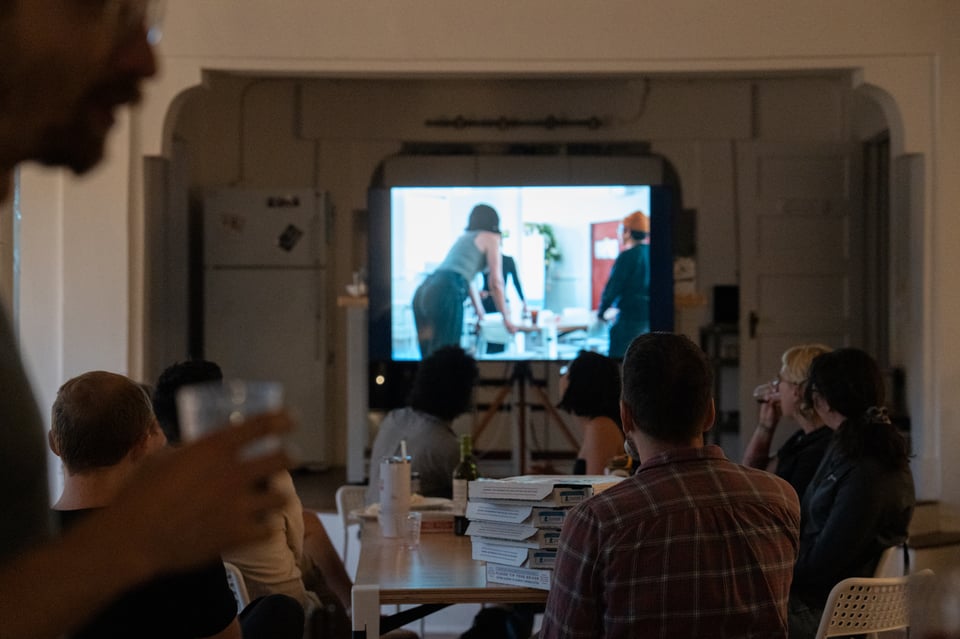 People sitting around a table looking at photos.