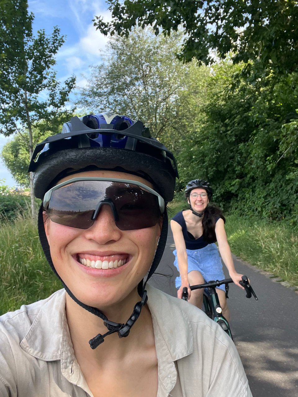 Selfie of Jenny and Chrisi biking along a cycleway