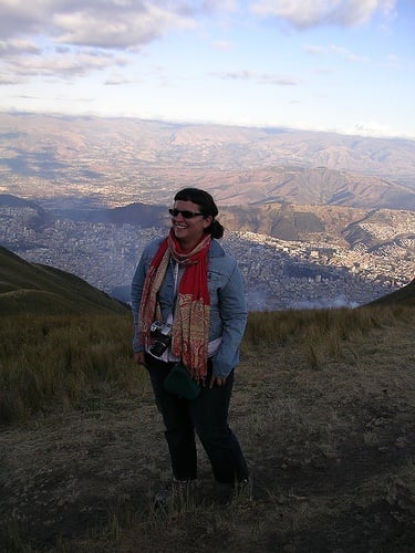 a woman standing on top of a mountain