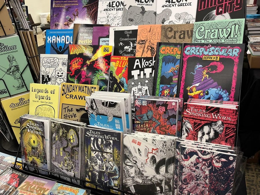 A display rack of a bunch of DCC zines by 3rd party publishers. Such lurid, colorful covers!