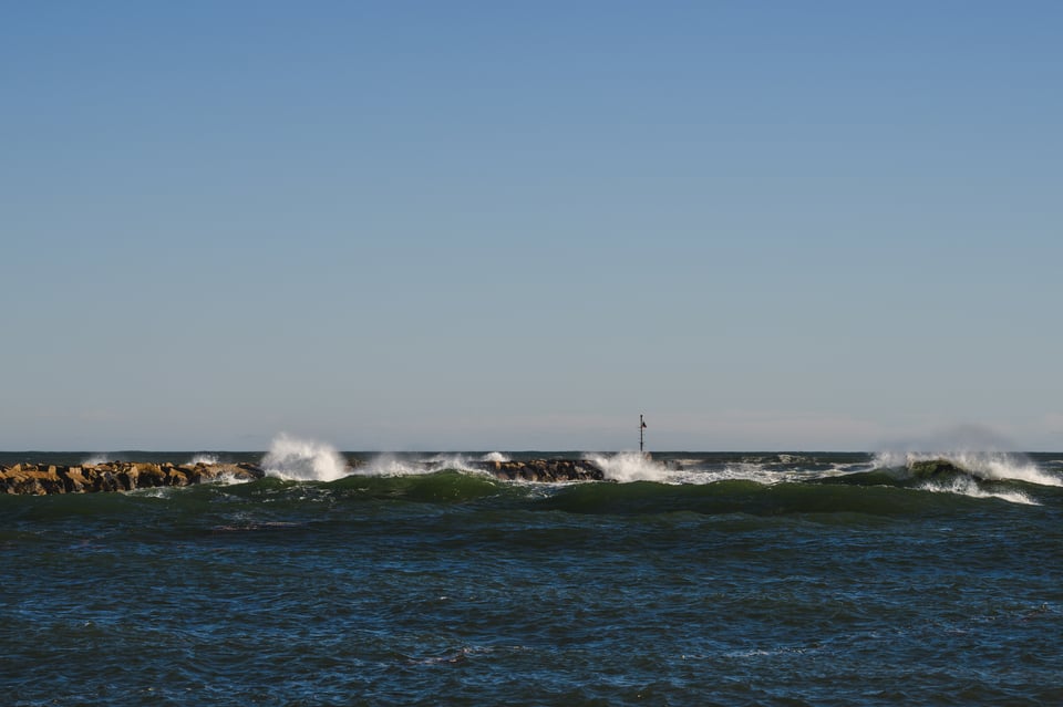 a jetty being hit by waves in the ocean