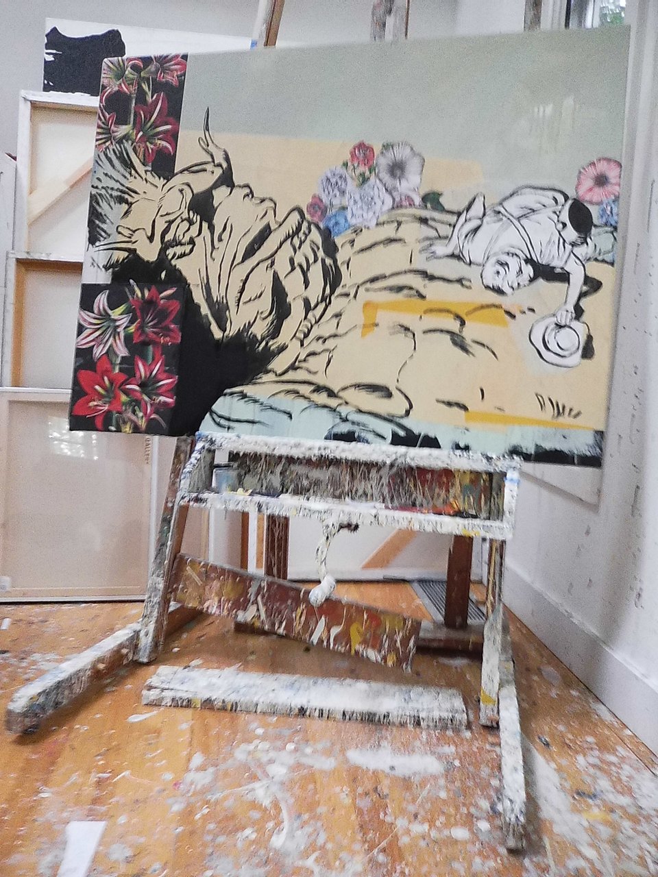 digital Instax photo of a painting on a very paint-dripped easel. The canvas is a pastiche of a Jack Kirby monster comic, with a scientist leaning down to check out the heartbeat of a fallen monster. Flowers are painted around the scene