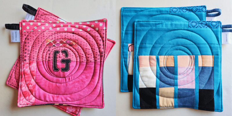 Two sets of patchwork potholders made by Sarah Atlee to look like album covers. The pair on the left is mostly pink with a black letter G. The pair on the right is mostly blue with four abstract figures representing people.