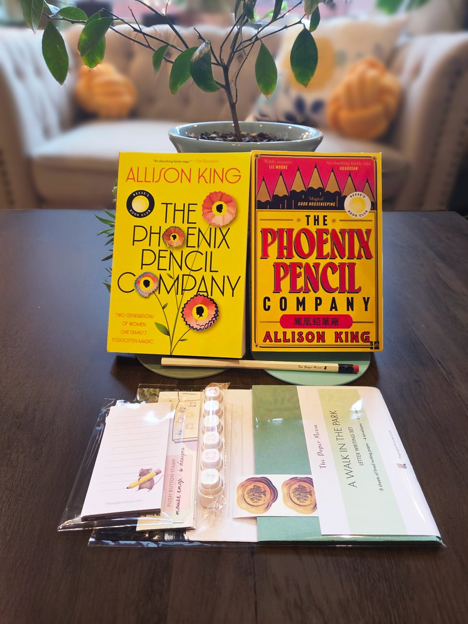 The US and UK paperback editions of The Phoenix Pencil Company surrounded by awesome Paper Mouse products
