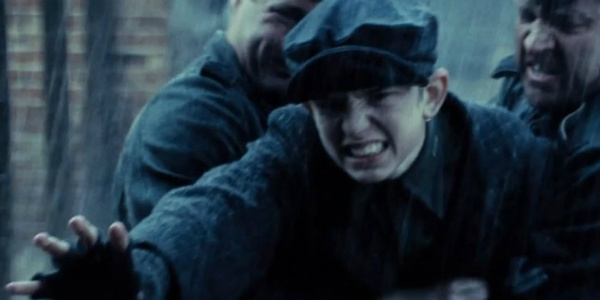 an image of a young Magneto stretching out his hands to twist the metal of a gate