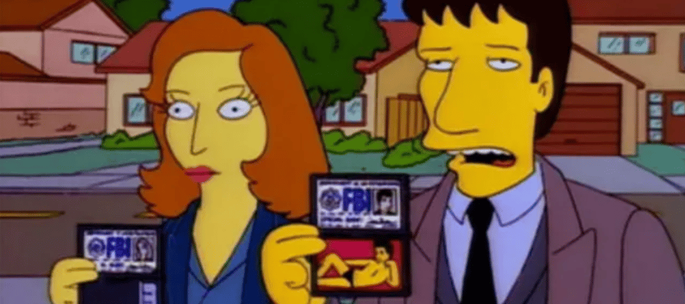Mulder and Scully as seen in the Simpsons crossover episode. They hold their FBI badges. Instead of credentials, Mulders features David Duchovny's iconic 90's centrefold.