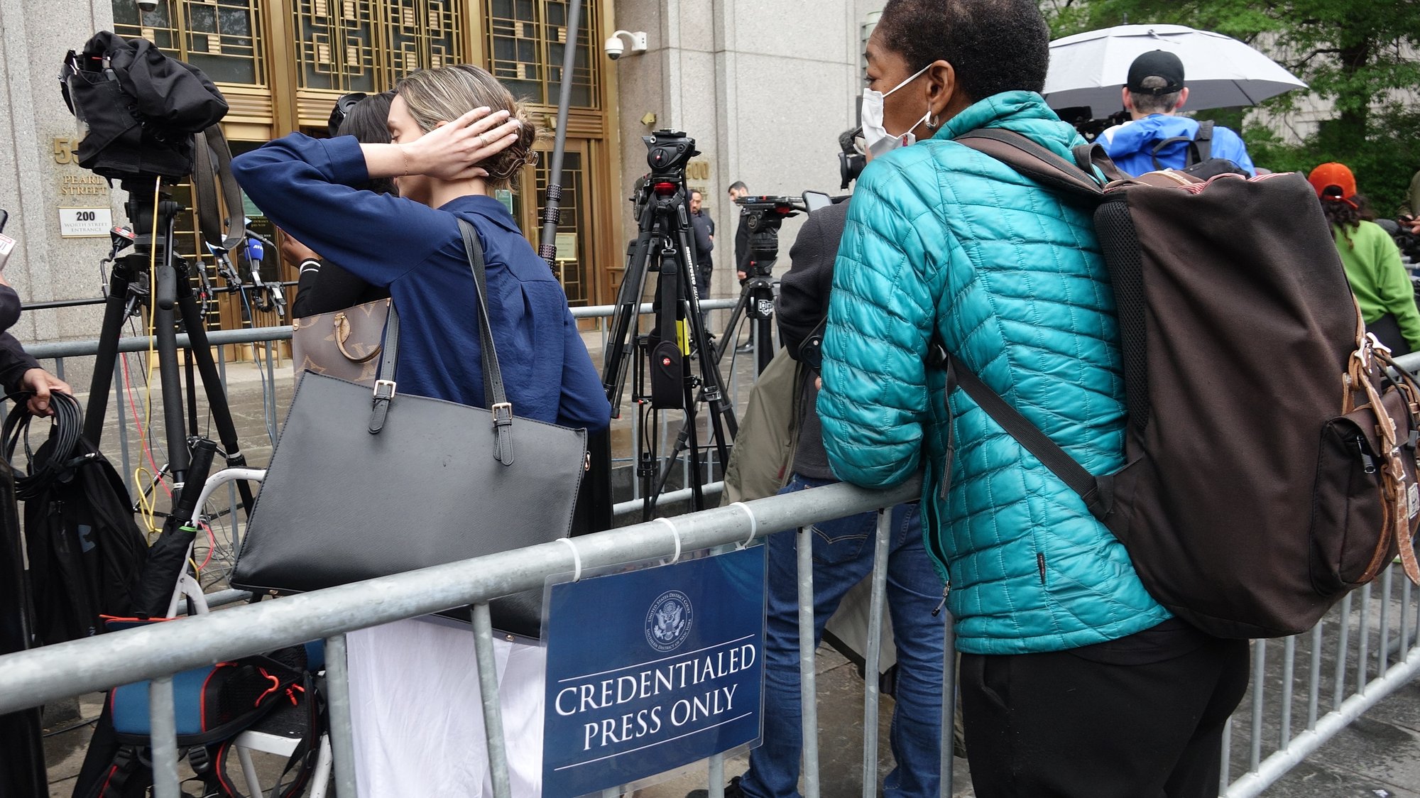 Credentialed press gathered behind a barricade outside the Manhattan federal courthouse during the Sean Combs trial, May 13, 2025.